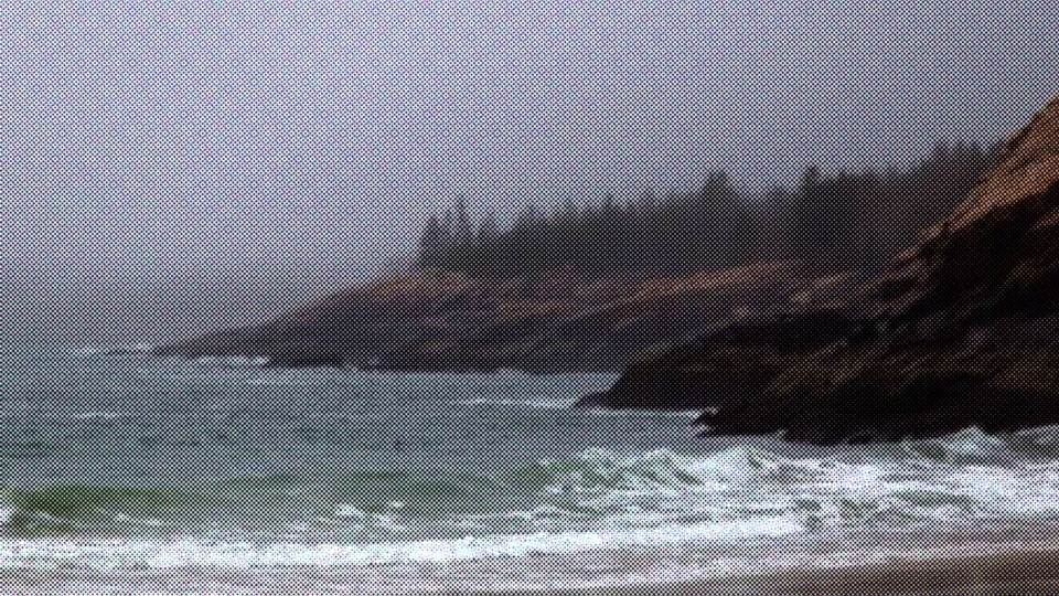 Rocky island cove with waves breaking on shore