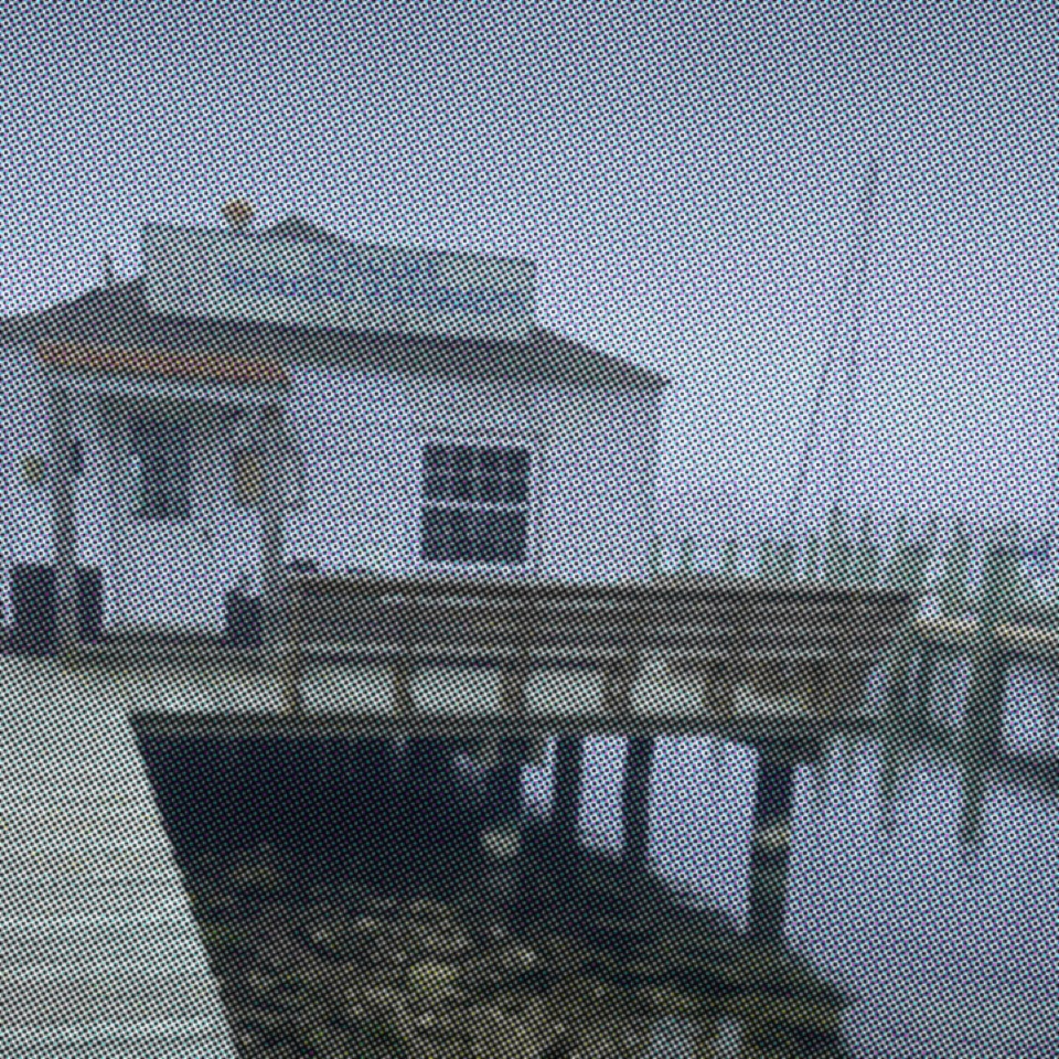 Small harbor office at the end of a weathered pier